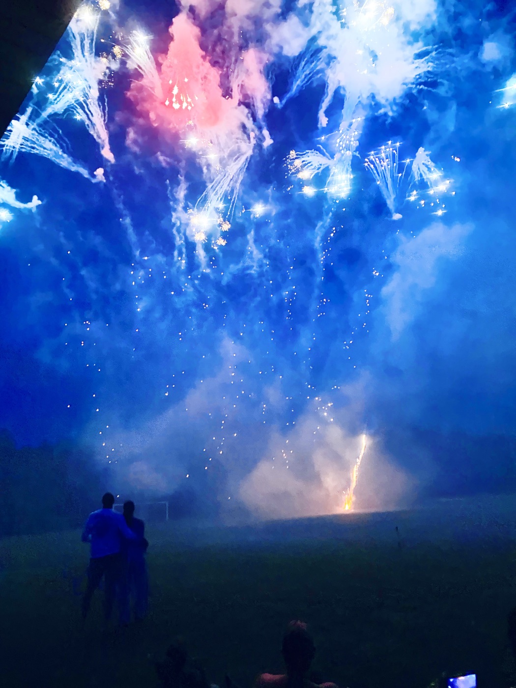 Red and blue fireworks filling the night sky